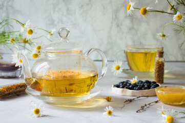 Chamomile tea. Herbal tea in a cup and teapot