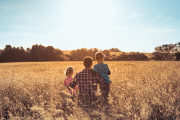  Fatherhood, and family parenting concept. Father and his children spending time together in nature...