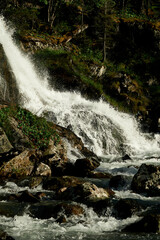 Waterfall of Lake Poperechnoe on the Multa River in the Katunsky Reserve of Altai