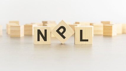 wooden cube with the letter from the npl word. npl - Non Performing Loans