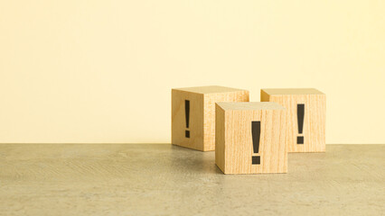 exclamation marks are written on wooden blocks. Blocks are located on a red background