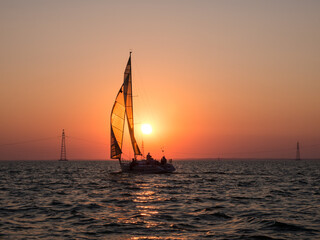 Yachts in the regatta against the backdrop of the sunset sky