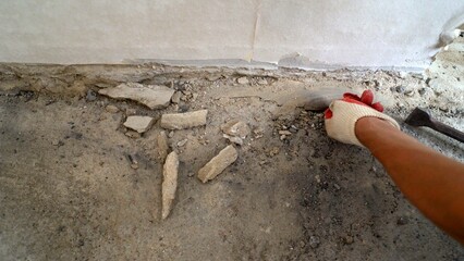 Old crumbling floor in an old apartment. Old and crumbled floor. Old concrete floor in the apartment.
