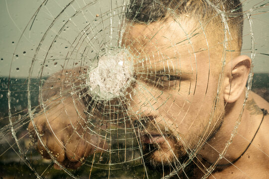 Sexy gangster man. Dangerous criminal, hooligan guy on cracked bullet glass.