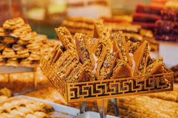 Various Turkish delights sweets and traditional authentic helva candy with nuts for sale at market showcase. Tasty shop business concept