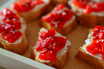 small sandwiches with pickled red bell peppers. catering services for the party.