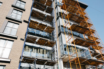 Fototapeta premium beautiful construction site background on a sunny day with scaffolding in stylish colors