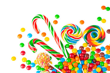 Colorful lollipops and different colorful round candy. Top view.