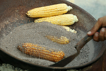 Corn being cooked in coal