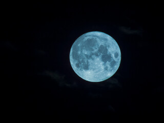Naklejka na ściany i meble Close-up photo of the full moon against a dark sky