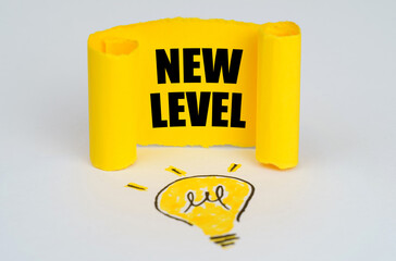 A light bulb is drawn on a white background, next to it is a yellow plate with the inscription - New Level
