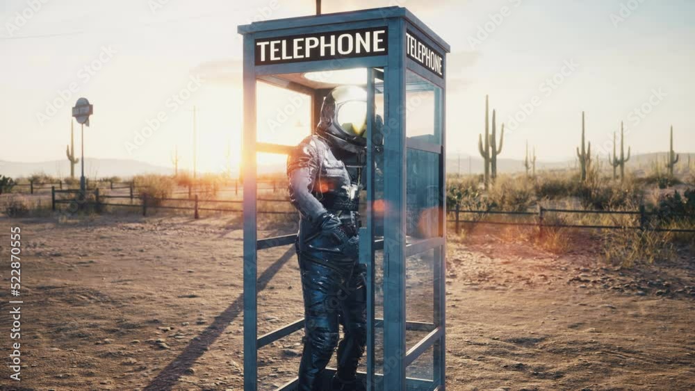 Wall mural an astronaut is chatting on an ancient phone with his space center. an astronaut in a phone booth. a