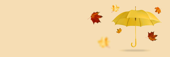 Yellow umbrella with leaves on an orange background