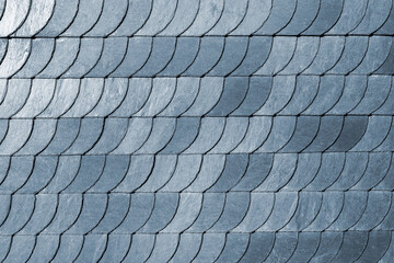 Detail close-up of natural grey stone shingle slate tiles texture roof abstract surface background. Natural mineral material dark rock plate building wall exterior design backdrop