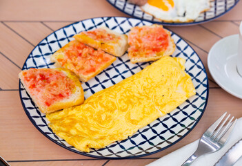 Healthy omelet and sweet jam sandwiches on a plate