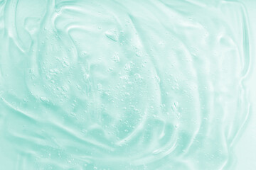 Hyaluronic acid clear serum sample. Cosmetic gel texture with bubbles background. Liquid green oil...