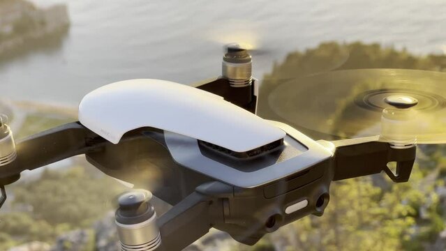 Four-engine drone with spinning propellers is filming