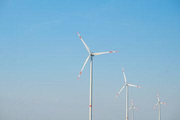 Wind renewable energy.Windmills on a blue sky background.Wind generators. Natural energy.Alternative energy sources.
