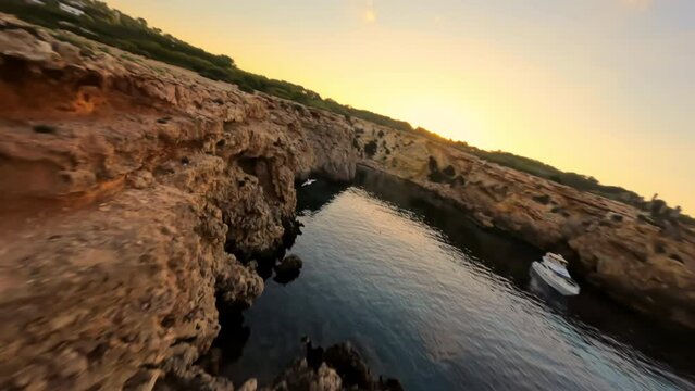 Fpv drone flying around Time and Space spot, in Cala Llentia, Ibiza. July 2022