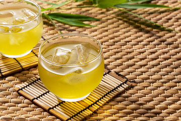Cold green tea placed on a straw rancho mat.