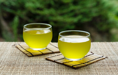 Cold Japanese green tea placed in a place with a view of the garden.