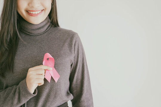 Young Asian Woman With Pink Ribbons, Breast Cancer Awareness, October Pink Concept, World Cancer Day