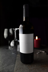 Wine bottle with wine glasses and candle