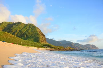Fototapeten Uncrowded beach coastline with mountains at sunset along the west side of Oahu Island in Hawaii © Ryan Tishken