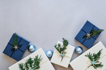 Ivory and blue Christmas gifts on gray background