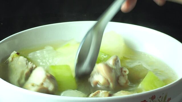  Wax gourd chicken soup in bowl, in door  Chiangmai  Thailand.