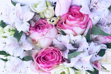 Pink roses and white alstroemeria in an idle bouquet. Solid floral background. Background for a greeting card.