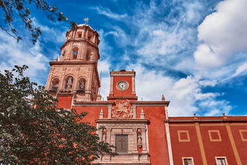 Santiago de Queretaro, Queretaro, Mexico, 09 07 22, Main entrance next to the tower and bell of the.Temple of San Francisco de Asís with a blue sky and clouds, no people