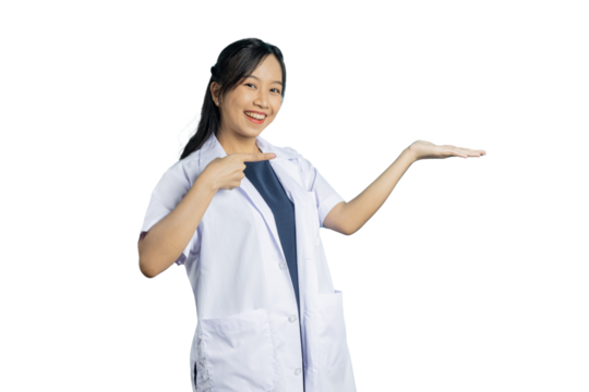 Portrait of young Asian beautiful nurse in white uniform with big smiled show hand to present your product or text on copy space blue background.