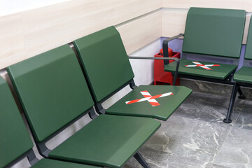 Social distancing on chairs in the waiting room. Covid-19 pandemic.