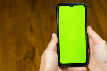 green chroma key hand with phone mockup pattern...