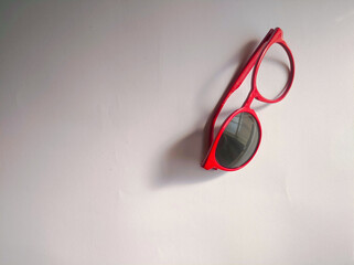 Flat lay photo of red broken glasses isolated over white background