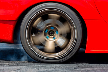 Car wheel spinning wheel and smoking, Race car burning tire for warm up tire before competition,...