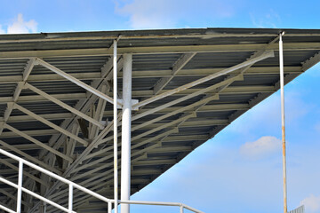 Fototapeta premium Fragment of the grandstand of the old stadium on a summer day