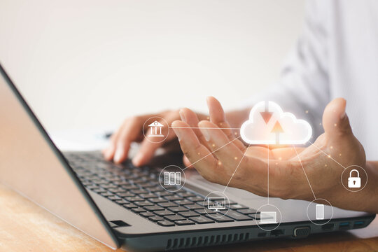 Man working with a computer laptop and showing cloud computing diagram in hand on the desk in the home office. Cloud technology. Data storage. Networking and internet service concept.