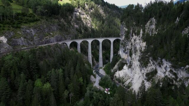 The Glacier Express travels over the famous Landwasser Viaduct in Switzerland. One of the landmarks of Switzerland and the railroads in the canton of Grisons