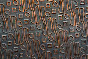 Traditional indonesian batik textured on steel. wall of steel is carved with batik motif. batik on metal plate surface.