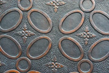 Traditional indonesian batik textured on steel. wall of steel is carved with batik motif. batik on metal plate surface.