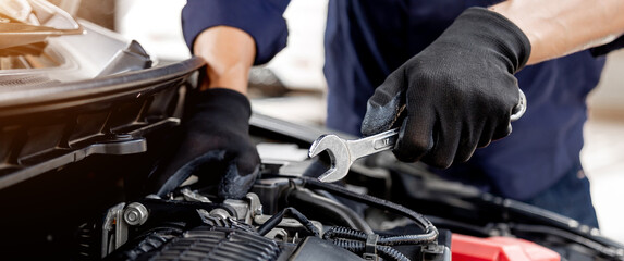 Plakat Car care maintenance and servicing, Close-up hand technician auto mechanic using the wrench to repairing change spare part car engine problem and insurance service support.