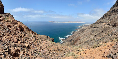 Aerial and Amazing view of beautiful volcanic island La Graciosa island. Panoramic view near Famara Risco, Lanzarote. Location: north of Lanzarote, Canary Islands, Spain. Ocean view.
