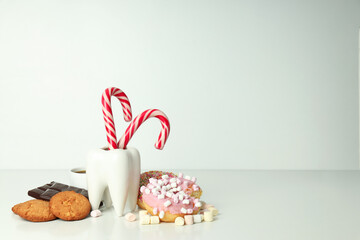 Concept of food bad for teeth on light background