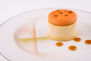 Piece of delicious cake with caramel on white plate