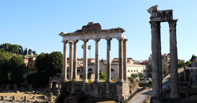 Tourists visiting Temple of Saturn and Temple of Vespasian and Titus in the Roman Forum in Rome, Italy.