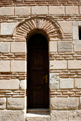 Fototapeta na wymiar stone walls and wooden door of an old building