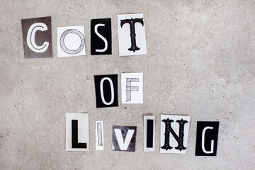 Cost of living, written with lettering from magazine clippings on mottled grey