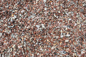 Pebbles on the beach, natural background of small stones